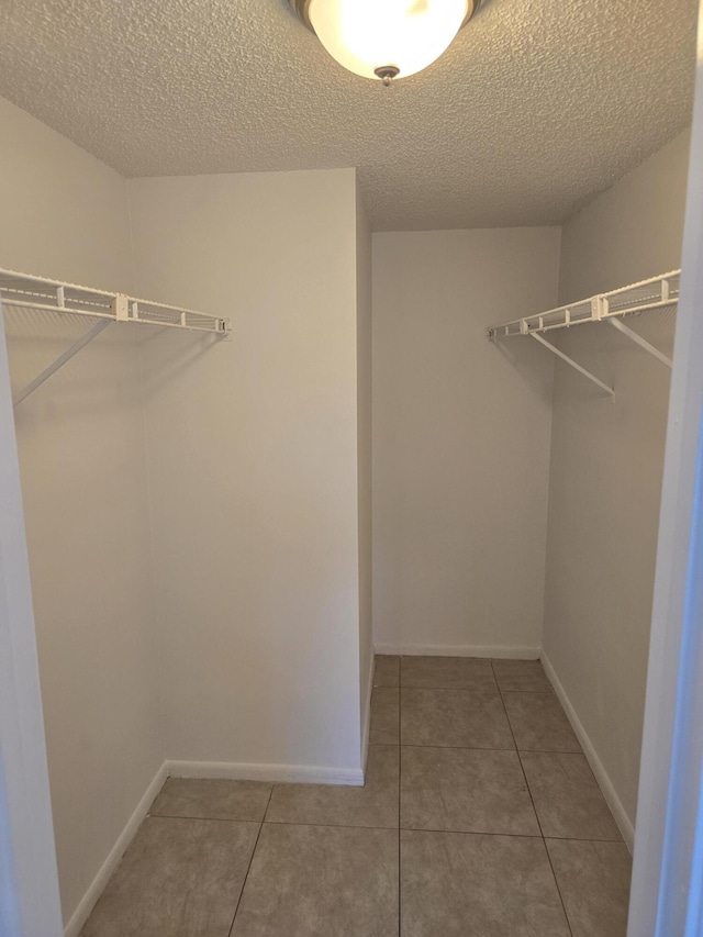 spacious closet featuring tile patterned floors