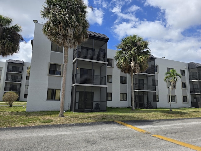 view of building exterior featuring uncovered parking