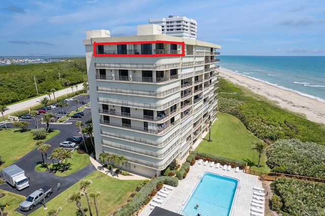 aerial view of extended coastline, apartment complex / building, and a pool