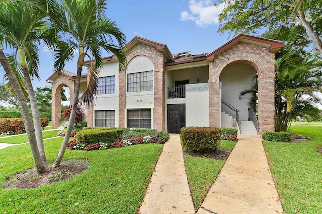 view of front of house featuring a front lawn and stucco siding