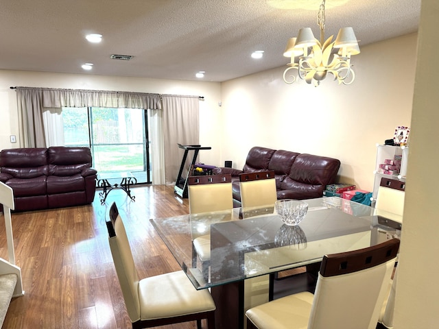 3779 Carambola Cir N Unit 28102, Coconut Creek, FL 33066 - dining room featuring a chandelier, wood finished floors, a textured ceiling, and recessed lighting