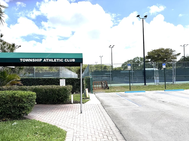 3779 Carambola Cir N Unit 28102, Coconut Creek, FL 33066 - surrounding community with uncovered parking and a tennis court