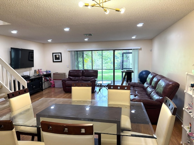 3779 Carambola Cir N Unit 28102, Coconut Creek, FL 33066 - living area with wood finished floors, a textured ceiling, a chandelier, recessed lighting, and stairs