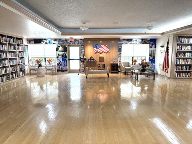3779 Carambola Cir N Unit 28102, Coconut Creek, FL 33066 - misc room with a textured ceiling, hardwood / wood-style flooring, and bookshelves