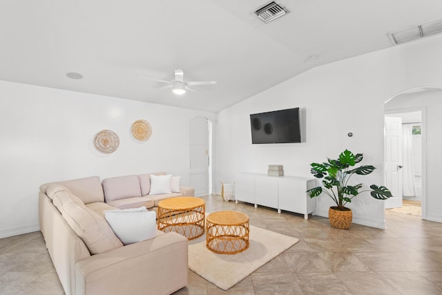 living room with arched walkways, vaulted ceiling, ceiling fan, and baseboards