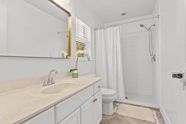 bathroom with toilet, vanity, and a tile shower