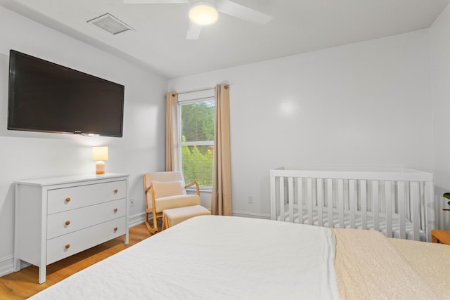 bedroom with wood finished floors, a ceiling fan, and baseboards
