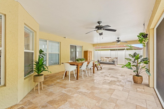 view of patio / terrace with outdoor dining area, a ceiling fan, fence, and outdoor lounge area