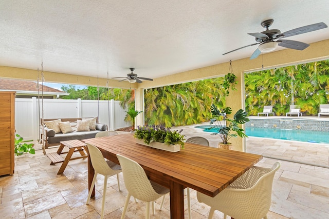 view of patio / terrace with a ceiling fan, outdoor dining area, fence, and an outdoor hangout area