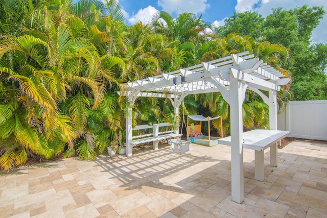 view of patio / terrace with a pergola, outdoor dining space, and fence