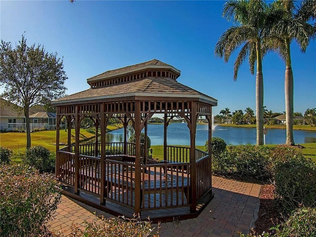 view of community featuring a gazebo, a water view, and a lawn