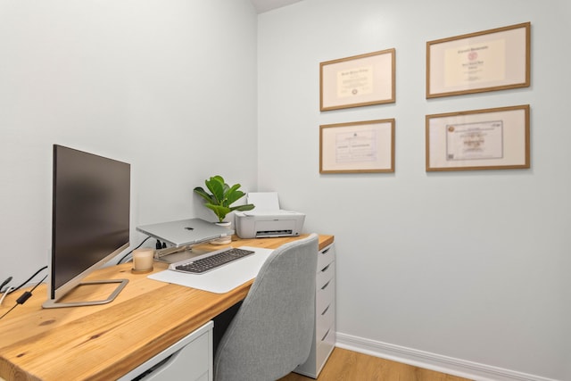 office space featuring light wood-style floors and baseboards