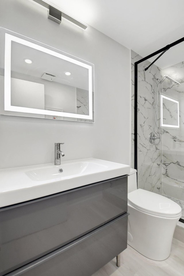 373 Piedmont H, Delray Beach, FL 33484 - full bathroom with toilet, vanity, and a marble finish shower