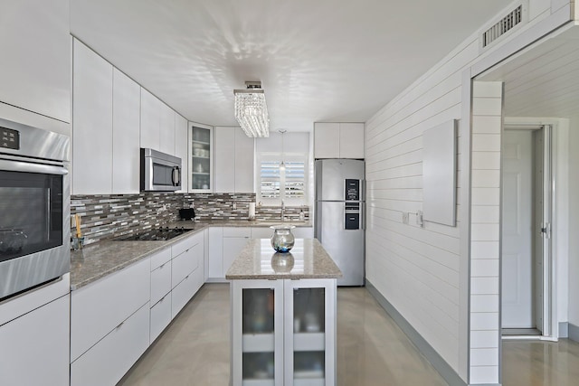 kitchen featuring modern cabinets, visible vents, stainless steel appliances, and white cabinets