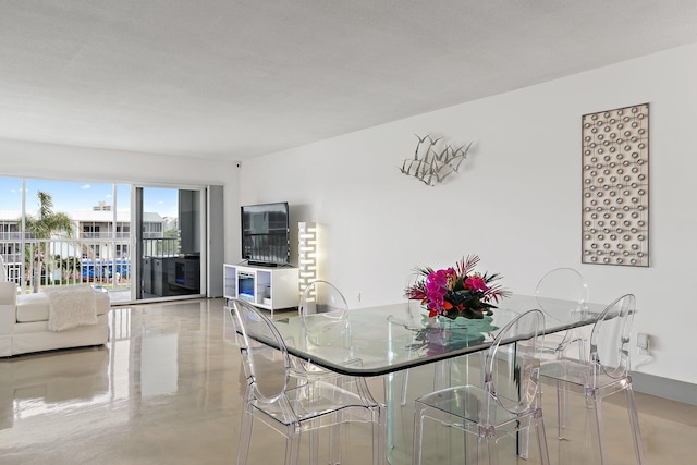dining space featuring finished concrete flooring
