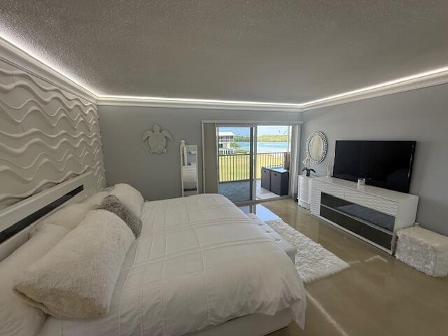 bedroom featuring ornamental molding, access to outside, and a textured ceiling