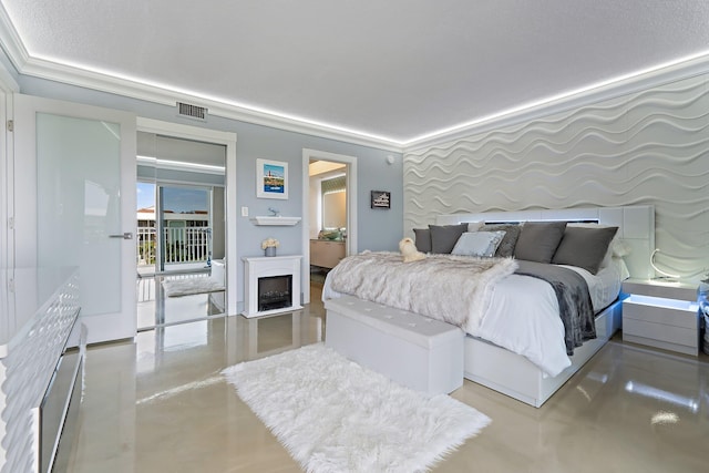 bedroom featuring ornamental molding, finished concrete floors, visible vents, and a fireplace
