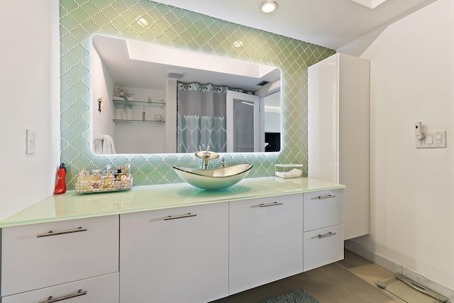 full bath featuring backsplash and vanity