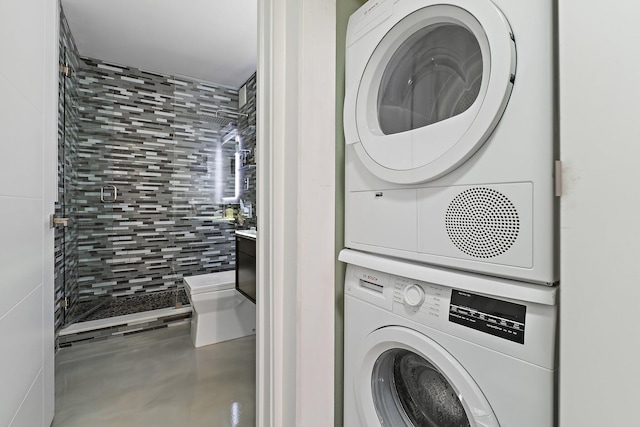 laundry area featuring stacked washer / dryer and laundry area