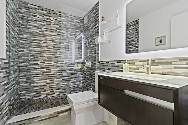full bath featuring tasteful backsplash, a stall shower, toilet, tile walls, and vanity