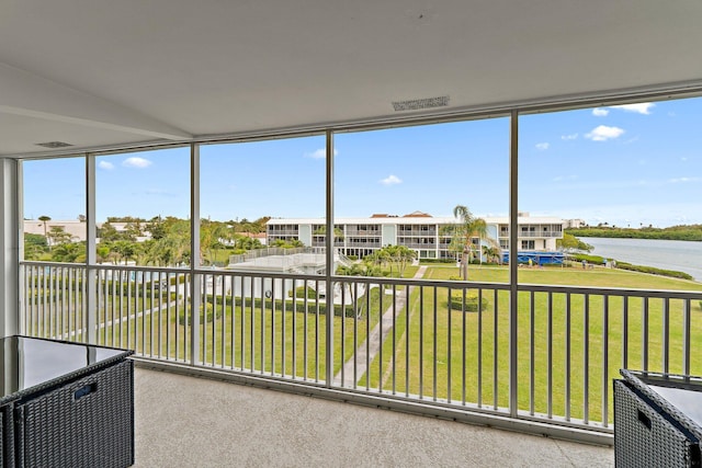 unfurnished sunroom with a water view and plenty of natural light