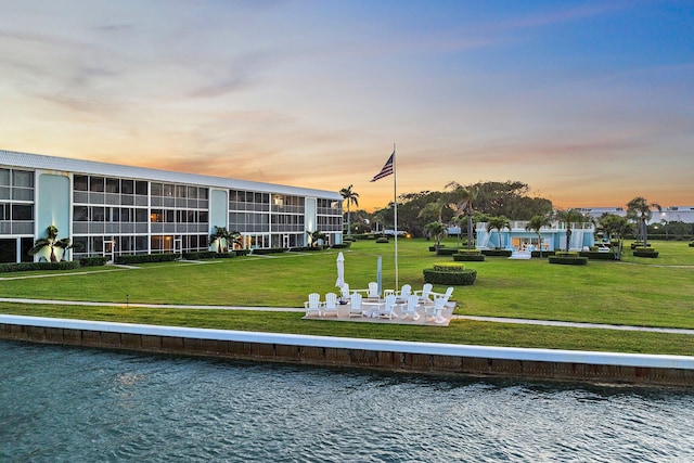 view of property's community with a yard and a water view