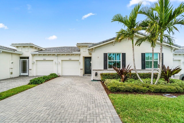 7113 Peters Ln, Delray Beach, FL 33446 - ranch-style home featuring stucco siding, an attached garage, stone siding, and decorative driveway