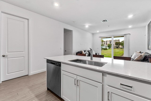 7113 Peters Ln, Delray Beach, FL 33446 - kitchen with open floor plan, a sink, visible vents, dishwasher, and light stone countertops