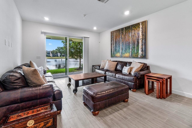 7113 Peters Ln, Delray Beach, FL 33446 - living room with wood tiled floor, a water view, baseboards, and recessed lighting