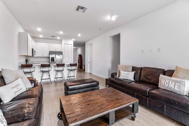 7113 Peters Ln, Delray Beach, FL 33446 - living area featuring light wood finished floors, baseboards, visible vents, and recessed lighting