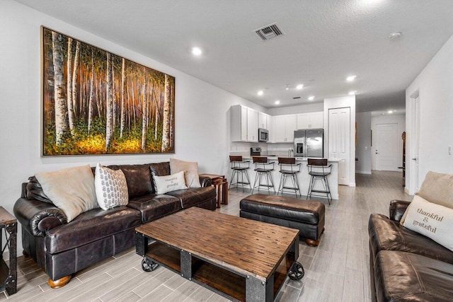 7113 Peters Ln, Delray Beach, FL 33446 - living area with visible vents, wood finish floors, and recessed lighting