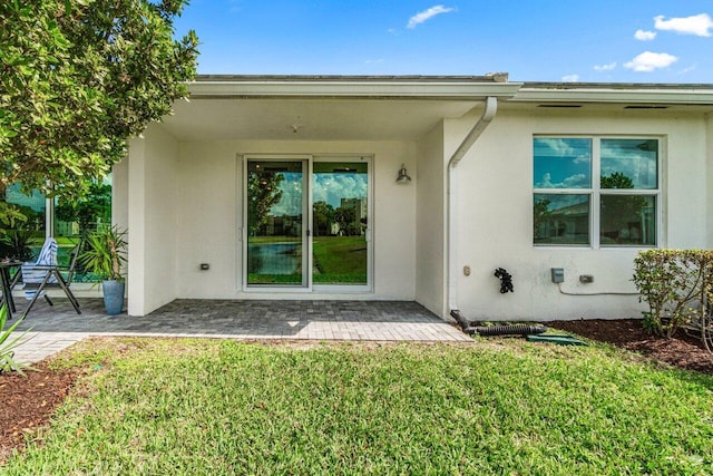 7113 Peters Ln, Delray Beach, FL 33446 - back of property with stucco siding, a yard, and a patio area