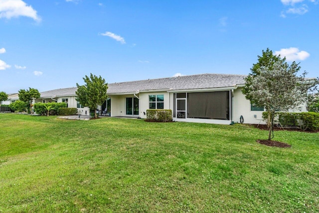 7113 Peters Ln, Delray Beach, FL 33446 - rear view of property with stucco siding, a sunroom, and a yard