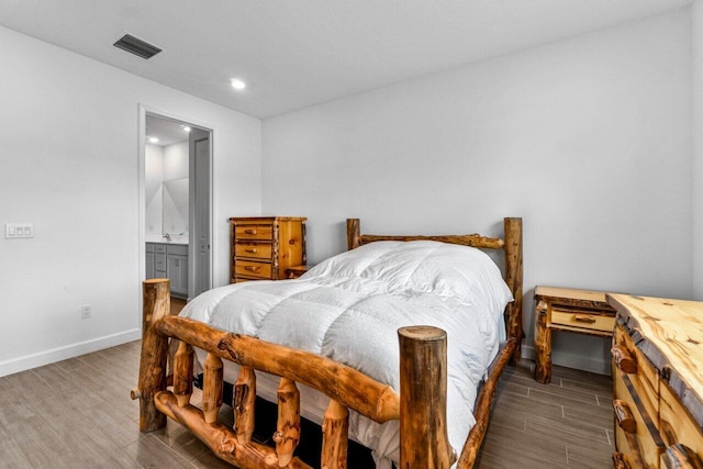 7113 Peters Ln, Delray Beach, FL 33446 - bedroom featuring ensuite bathroom, wood finish floors, baseboards, visible vents, and recessed lighting