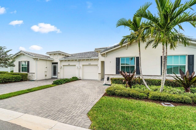 7113 Peters Ln, Delray Beach, FL 33446 - view of front of property featuring stucco siding, a garage, a tiled roof, and decorative driveway