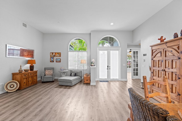 entryway with visible vents, baseboards, light wood-style floors, recessed lighting, and french doors