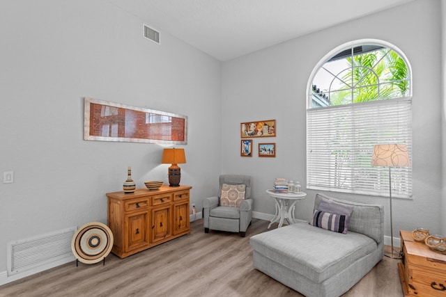 sitting room with visible vents, baseboards, and light wood-style flooring