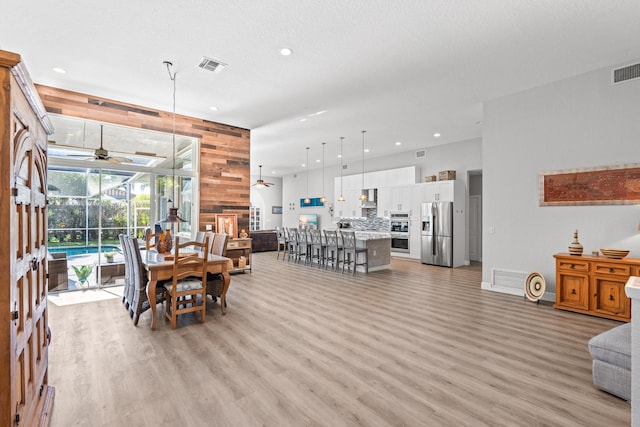 dining room featuring recessed lighting, light wood finished floors, visible vents, and a ceiling fan