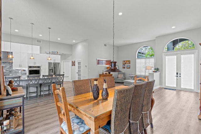 dining room with french doors, recessed lighting, visible vents, and light wood finished floors