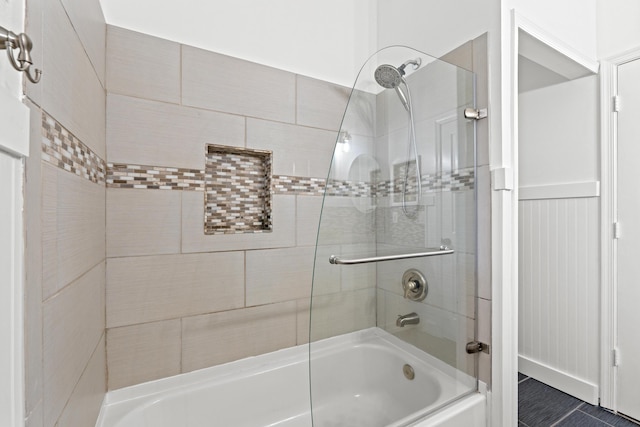 full bath featuring bath / shower combo with glass door