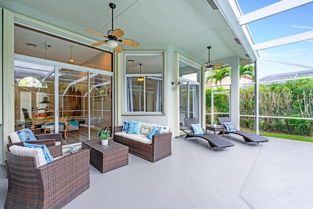 view of patio / terrace with ceiling fan, an outdoor living space, and a lanai