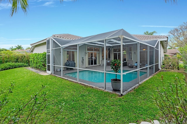 back of house with a yard, stucco siding, a patio, a tile roof, and an outdoor pool