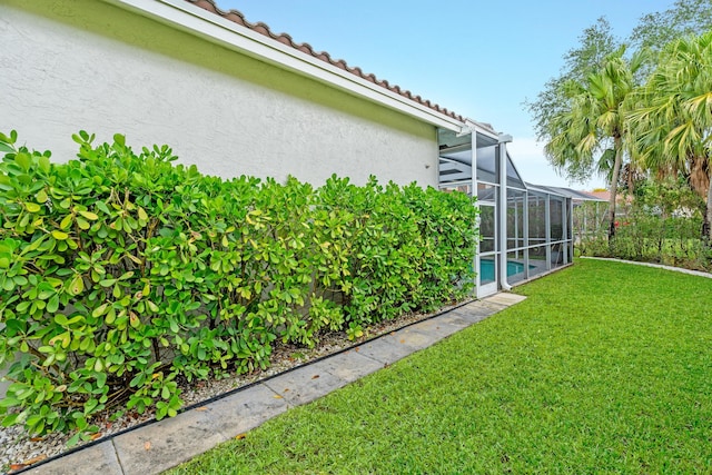 view of yard featuring an outdoor pool and glass enclosure
