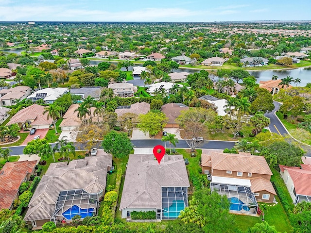bird's eye view featuring a water view and a residential view