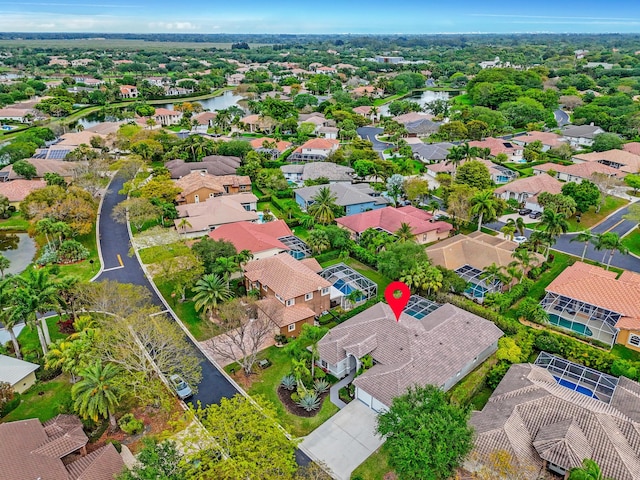 drone / aerial view with a water view and a residential view