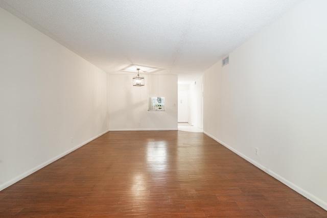 230 NE 26th Ave Unit 1030, Boynton Beach, FL 33435 - unfurnished room with baseboards, visible vents, wood finished floors, and a textured ceiling