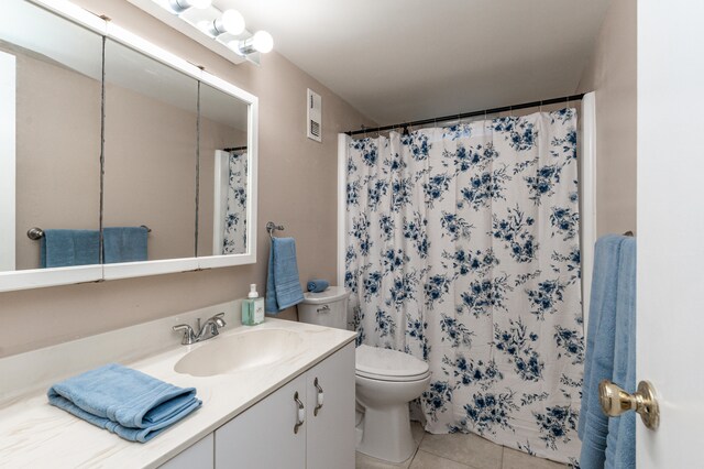 230 NE 26th Ave Unit 1030, Boynton Beach, FL 33435 - full bathroom featuring toilet, tile patterned floors, a shower with shower curtain, and vanity