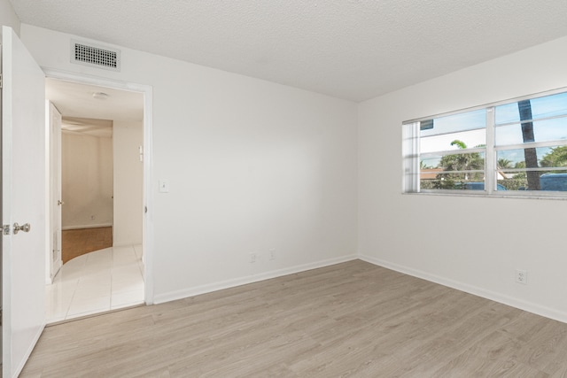 230 NE 26th Ave Unit 1030, Boynton Beach, FL 33435 - spare room with a textured ceiling, light wood-style floors, and visible vents