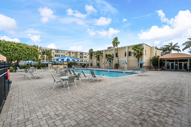 230 NE 26th Ave Unit 1030, Boynton Beach, FL 33435 - community pool featuring a patio area and fence