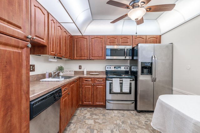 230 NE 26th Ave Unit 1030, Boynton Beach, FL 33435 - kitchen with a sink, a ceiling fan, appliances with stainless steel finishes, brown cabinets, and stone finish floor